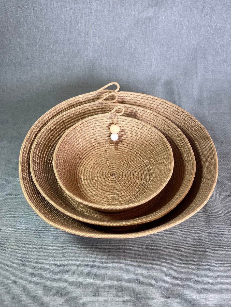 Three nested handmade rope bowls in natural taupe