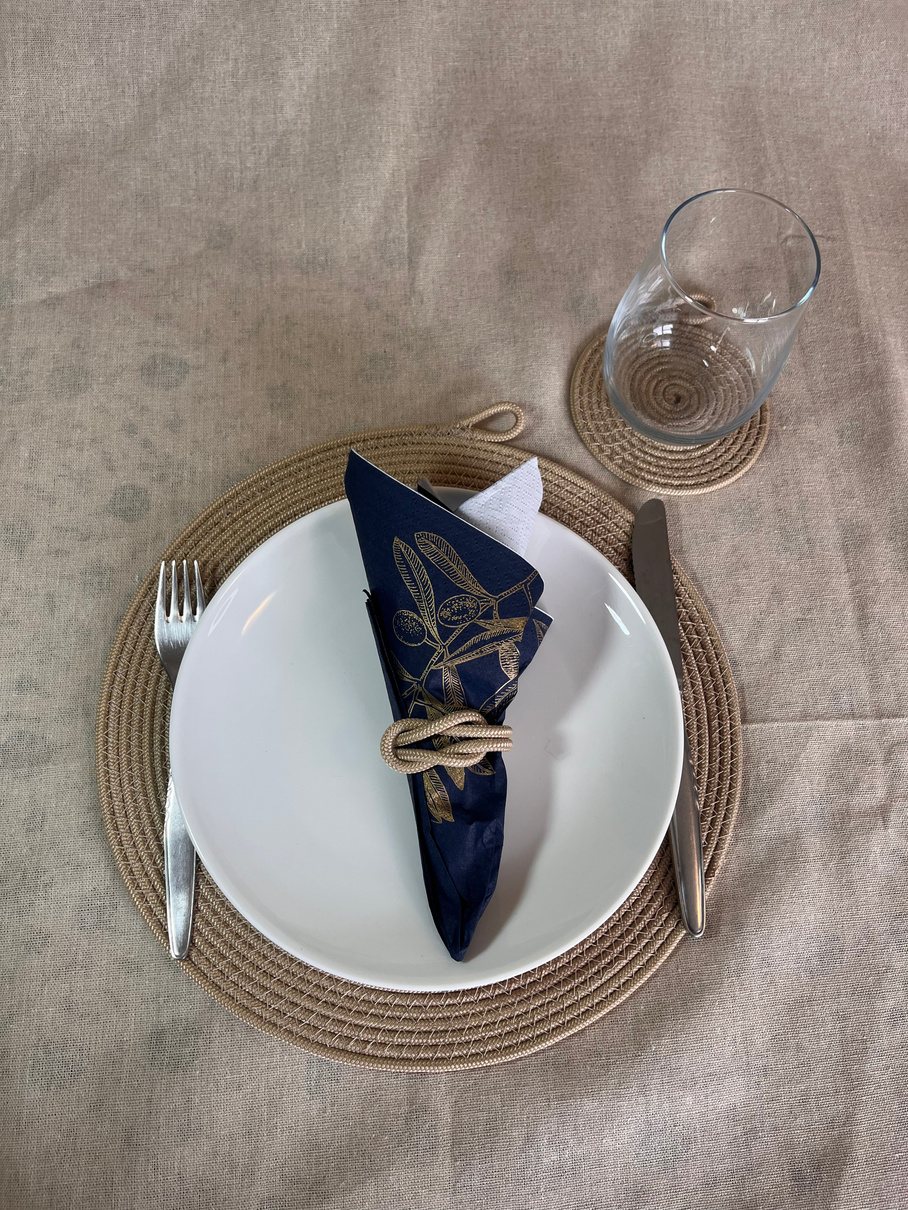Round woven rope placemat on a styled dining table